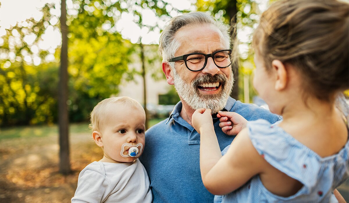 Man with greying beard, and children.